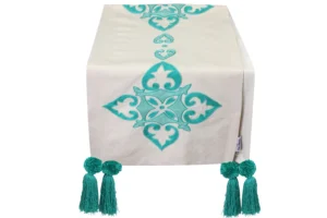 Hand-embroidered Arabesque table runner with pompoms in mint green